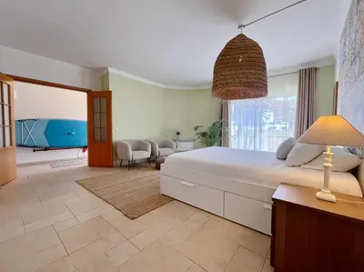 a bedroom with a large bed and a large window at V4 moderno com Piscina - Burgau in Burgau