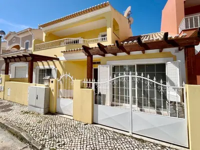 a house with a gate in front of it at V4 moderno com Piscina - Burgau in Burgau