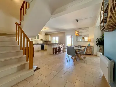 a kitchen and dining room with a staircase in a house at V4 moderno com Piscina - Burgau in Burgau