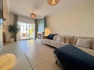 a living room with a couch and a table at V4 moderno com Piscina - Burgau in Burgau