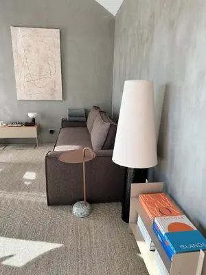 a living room with a couch and a table with a lamp at NEW! casa L, ocean view private pool Villa in Ponta do Sol