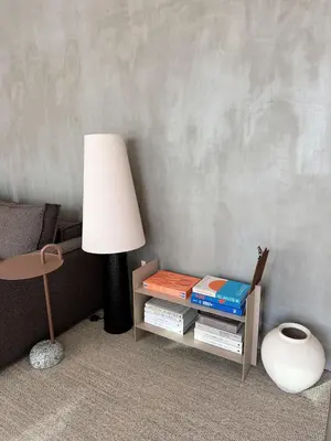 a lamp sitting next to a table with books at NEW! casa L, ocean view private pool Villa in Ponta do Sol