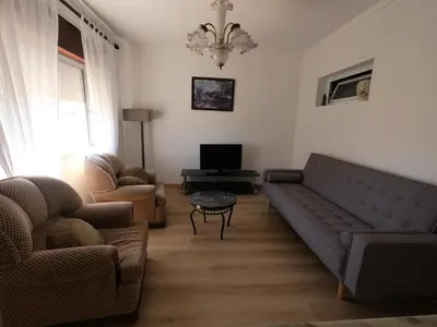 a living room with a couch and two chairs at Casa do Burgau in Burgau
