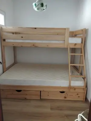 a bunk bed with a ladder in a room at Casa do Burgau in Burgau