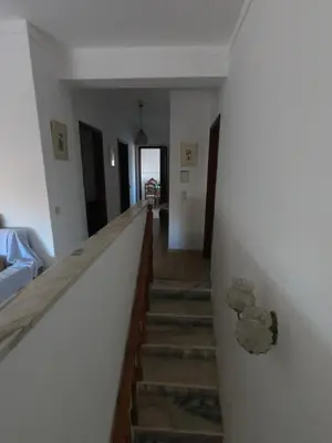 a hallway with a staircase in a house at Casa do Burgau in Burgau