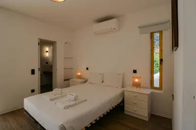 a bedroom with a large white bed with two lamps at FLH Praia da Luz Town House in Lagos