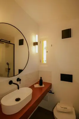 a bathroom with a sink and a mirror at FLH Praia da Luz Town House in Lagos