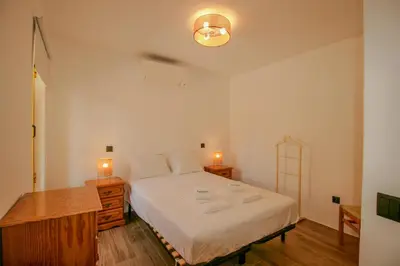 a bedroom with a white bed and two night stands at FLH Praia da Luz Town House in Lagos
