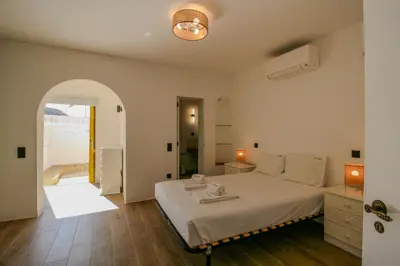 a bedroom with a large white bed in a room at FLH Praia da Luz Town House in Lagos