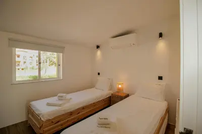 two beds in a small room with a window at FLH Praia da Luz Town House in Lagos