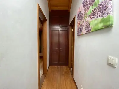 a hallway with a door and a painting on the wall at A charming spot in Estreito da Calheta