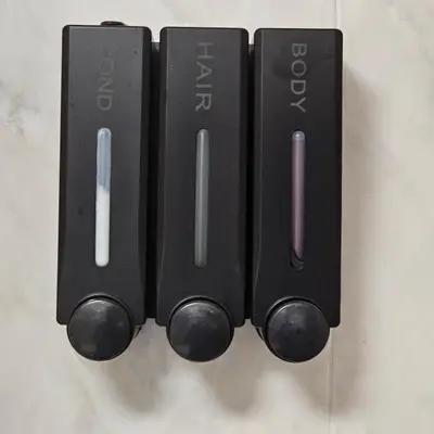 a group of black remote controls hanging on a wall at JoLi Larano - BBQ In in Machico
