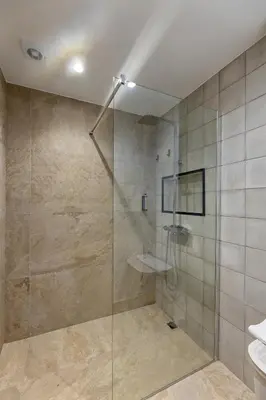 a bathroom with a shower with a glass door at THE SPOT- holiday concept in Santa Cruz