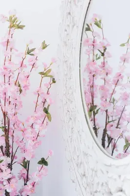 a mirror with pink flowers in front of a wall at Funchal City Yellow Townhouse and Terrace in Funchal
