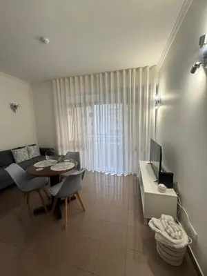 a living room with a table and a couch at Ávila Holidays in Funchal