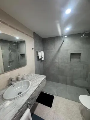 a bathroom with a sink and a shower at Ávila Holidays in Funchal