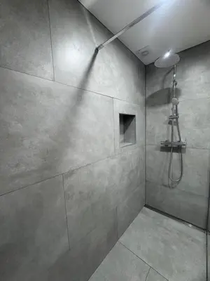 a bathroom with a shower with a light on the ceiling at Ávila Holidays in Funchal