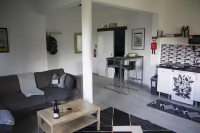 a living room with a couch and a table and a kitchen at House Villa Butterfly in Santana