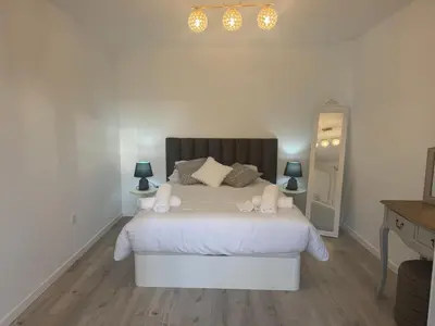 a bedroom with a bed with white sheets and pillows at Charming Seaside Flat in Paul do Mar