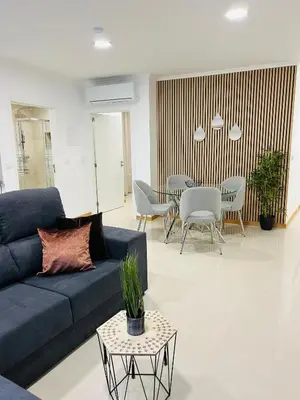 a living room with a blue couch and a table at Carreira Vicente by Olá Madeira in Funchal