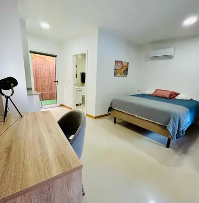 a bedroom with a bed and a wooden table at Carreira Vicente by Olá Madeira in Funchal