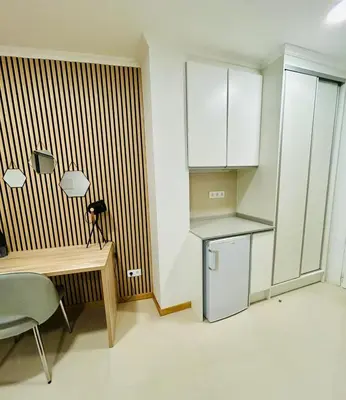 a small kitchen with a table and a refrigerator at Carreira Vicente by Olá Madeira in Funchal