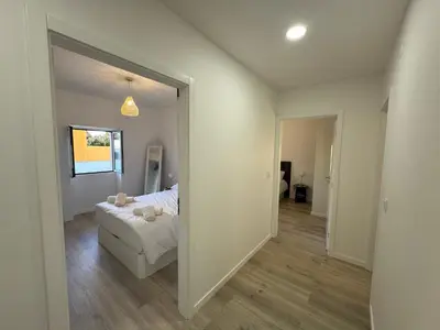 a bedroom with a bed and a large mirror at Charming Sunset flat in Paul do Mar