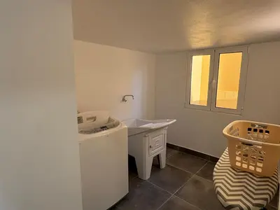 a small white bathroom with a sink and a desk at Charming Sunset flat in Paul do Mar