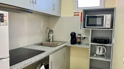 a small kitchen with a sink and a microwave at Domingos Reis Studio in São Vicente