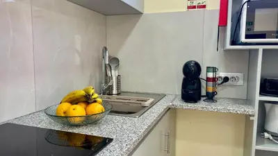 a bowl of fruit on a counter in a kitchen at Domingos Reis Studio in São Vicente