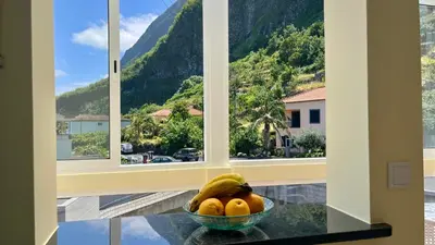 a bowl of fruit on a table in front of a window at Domingos Reis Studio in São Vicente