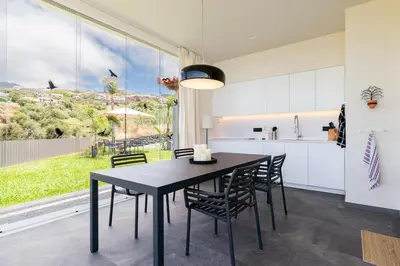 a kitchen with white counters and a counter top at Belo Horizonte in Estreito da Calheta