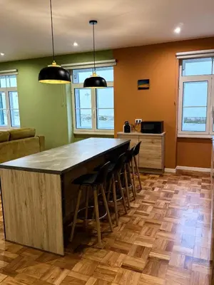 a kitchen with a large island with bar stools at Apartment Minorca 2 in Funchal