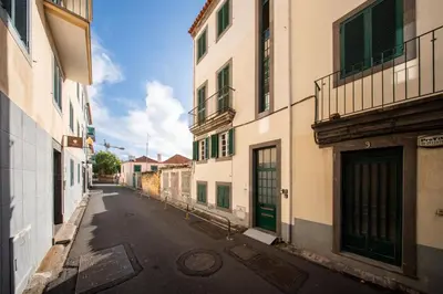 an empty street in an alley between two buildings at Sun & Roses in Funchal