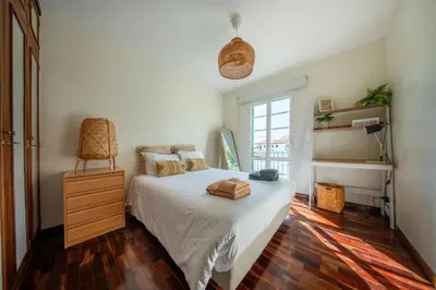 a bedroom with a white bed and a window at Sun & Roses in Funchal