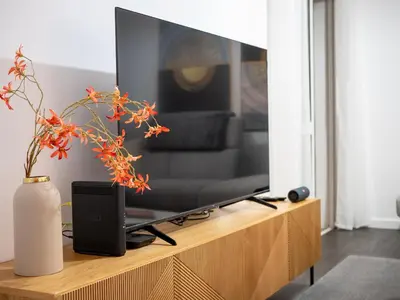 a television sitting on top of a wooden entertainment center at Lido Oasis Funchal in Funchal