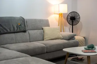 a living room with a couch and a table at Lido Oasis Funchal in Funchal