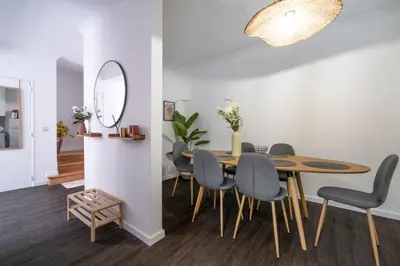 a dining room with a table and chairs and a mirror at Lido Oasis Funchal in Funchal