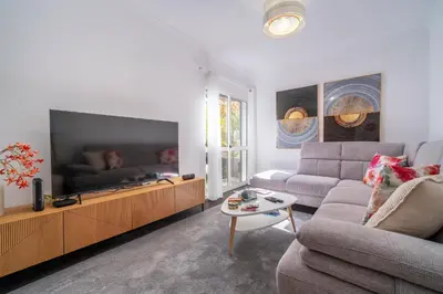a living room with a couch and a flat screen tv at Lido Oasis Funchal in Funchal