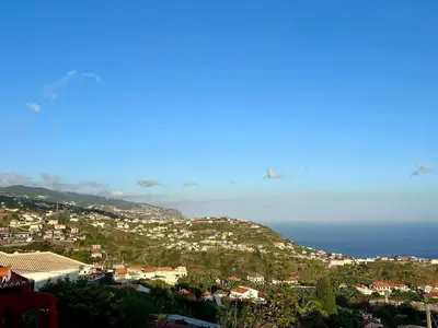 a town on a hill with the ocean in the background at Studio Refúgio in Ponta do Sol