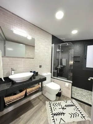 a bathroom with a sink and a toilet and a shower at Studio Refúgio in Ponta do Sol