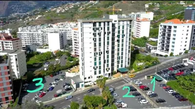 an aerial view of a city with a parking lot at Madeira Ocean Suite 1 in Funchal