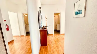 a hallway with white walls and a wooden floor at Madeira Ocean Suite 1 in Funchal