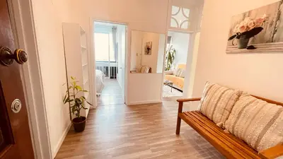 a living room with a bench and a hallway at Madeira 1003 in Funchal