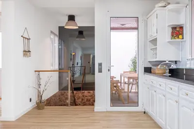 a kitchen with a door leading to a dining room at Flory House by ALMA Holiday Rentals in Funchal