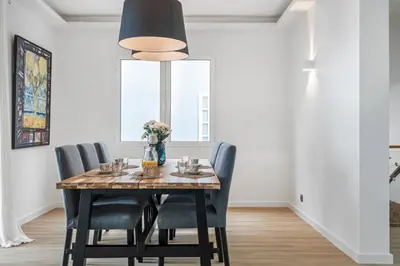 a dining room with a wooden table and chairs at Flory House by ALMA Holiday Rentals in Funchal