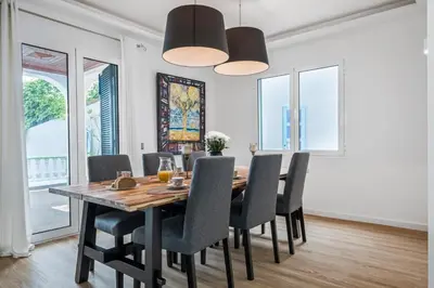 a dining room with a wooden table and chairs at Flory House by ALMA Holiday Rentals in Funchal
