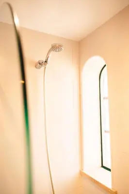 a shower in a bathroom with a window at Arrifana Surf Camp in Aljezur