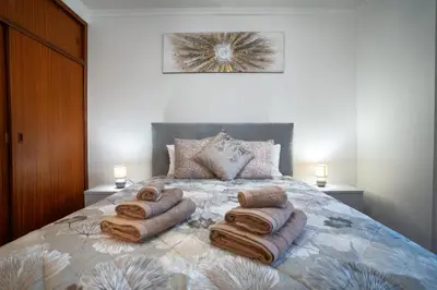 a bedroom with a bed with towels on it at Apartamento Brava JT in Ribeira Brava