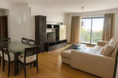 a living room with a couch and a glass table at Alojamiento Local - Nilia in Caniço